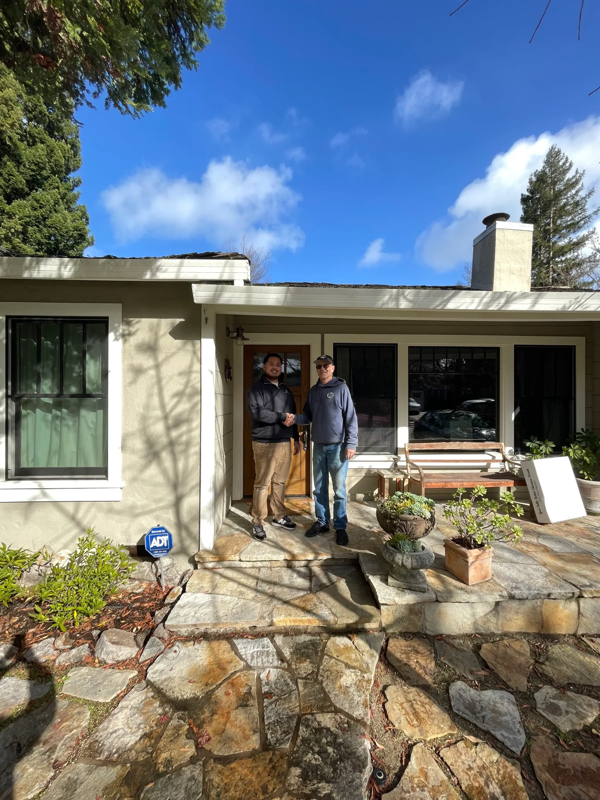Rey Sunga shaking hands with seller Peter outside his Menlo Park CA home after a successful cash sale
